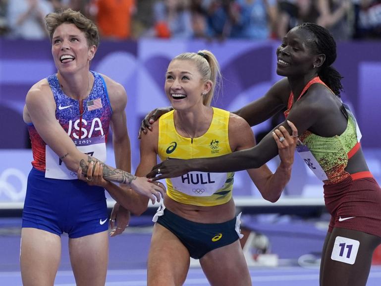 Jessica Hull, of Australia, is congratulated by Susan Lokayo Ejore, right, of Kenya, and Nikki Hiltz, of the United States, after her second place finish in the women's 1500-meter final at the 2024 Summer Olympics, Saturday, Aug. 10, 2024, in Saint-Denis, France. (AP Photo/Matthias Schrader)