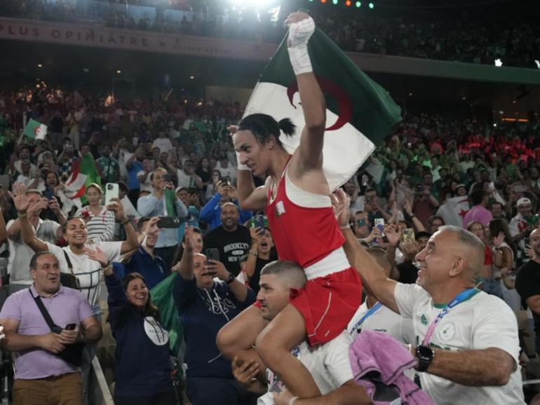 Algeria's Imane Khelif celebrates her boxing gold medal but has now submitted a legal complaint. (AP PHOTO)