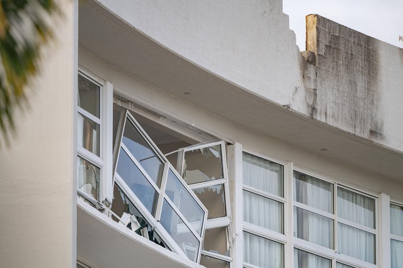 A broken window and damaged rooftop is seen at the Double Tree by Hilton Hotel after a helicopter crashed into its roof, in Cairns.