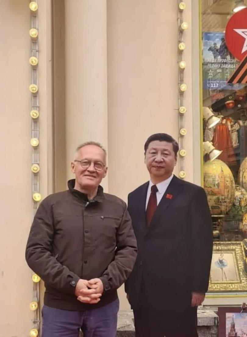 Igor Korolev standing beside a life-size figure of People's Republic of China President Xi Jinping.