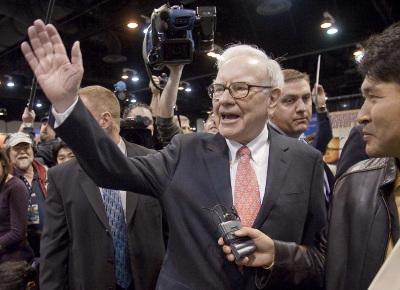 FILE - In this May 2, 2009 file photo, Warren Buffet, CEO of Berkshire Hathaway, right, waves to shareholders prior to the annual Berkshire Hathaway shareholders meeting in Omaha, Neb. Warren Buffet's Berkshire Hathaway said Tuesday, Nov. 3, 2009, it has agreed to buy Burlington Northern Santa Fe in a deal valuing the railroad at $34 billion.(AP Photo/Nati Harnik, file)