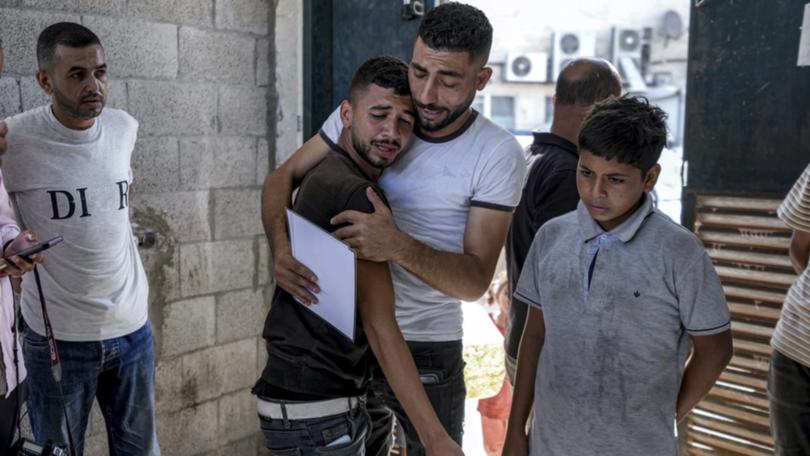Family members mourned the death of a mother and her twins in an Israeli attack on Deir al-Balah.