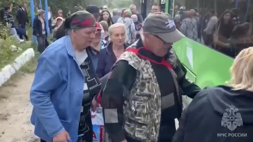 People board a bus during evacuation in Russia's Kursk region