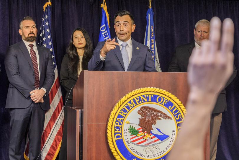 United States Attorney Martin Estrada, at podium, takes questions from the media after announcing court filings related to the death of actor Matthew Perry.