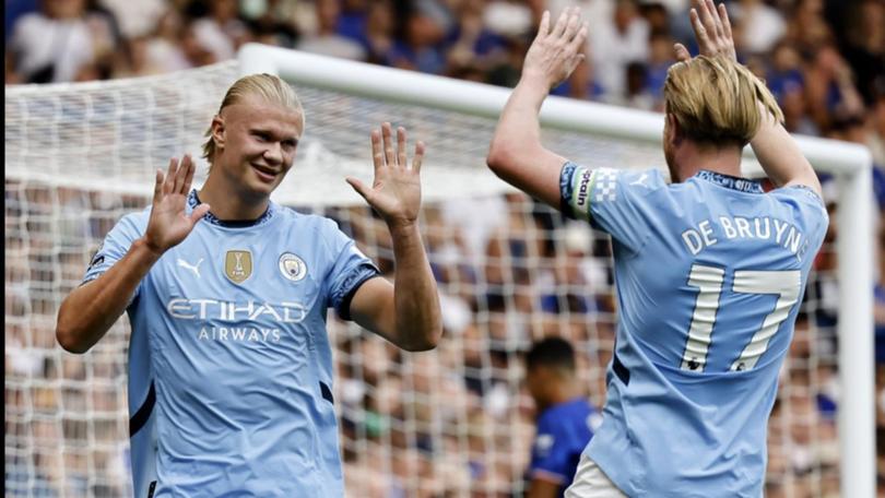 Erling Haaland (l) celebrates after his opener in the 2-0 win over Chelsea.