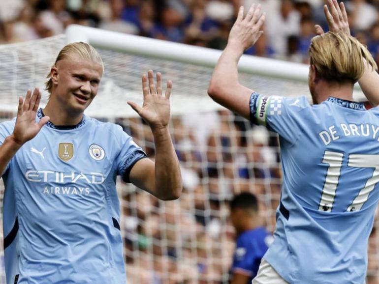 Erling Haaland (l) celebrates after his opener in the 2-0 win over Chelsea.