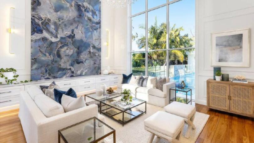 The luxury modern mansion sold for $10.8 million at auction in a weekend when auction numbers were slightly up.