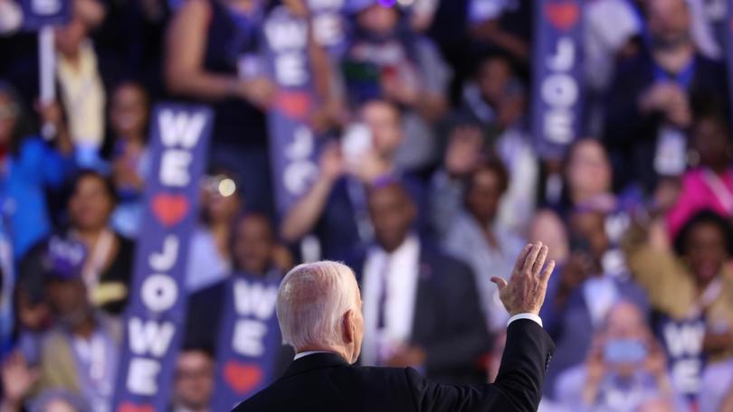  President Joe Biden acknowledges applause during the first day of the Democratic National Convention in Chicago.