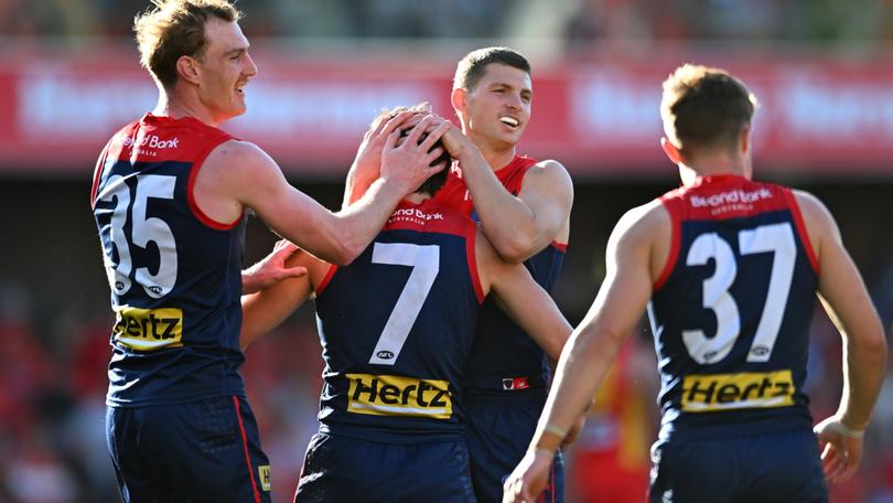Jack Viney celebrates with teammates after kicking a goal during the round 23 match between Gold Coast Suns and Melbourne.