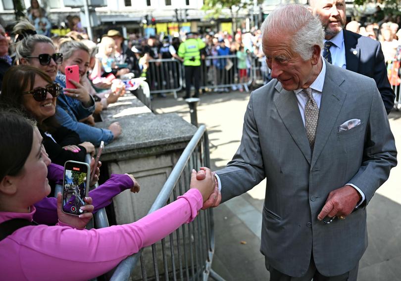 King Charles shakes hands with a Southport local during his visit to the town.