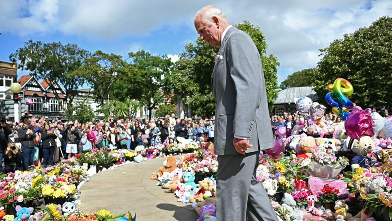 King Charles III views tributes to the victims of the stabbing rampage outside Southport Town Hall. 