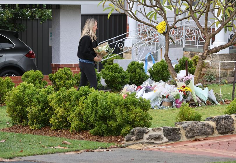 Flowers and other tributes adorn the front lawn of the home of Jennifer and Gretl Petelczyc in Floreat. 