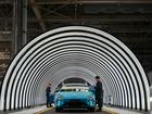 Employees work on the production line of electric vehicles at Xiaomi's Electric Vehicle Factory in Beijing.