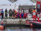 A body bag is brought ashore at the harbour in Porticello by rescue workers involved in search efforts after the luxury yacht Bayesian sank on Monday.