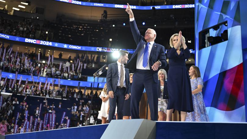 Tim Walz with wife Gwen and friends and family members onstage during the third day of the Democratic National Convention.