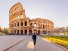 Rear view of a man walking towards Coliseum, Rome, Italy Alexander Spatari