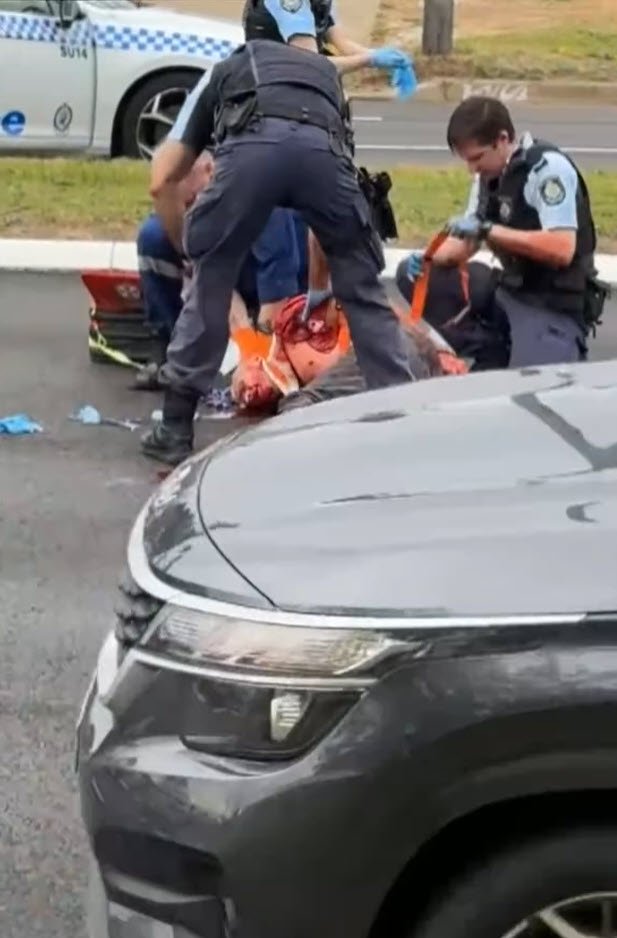The man is held on the ground.