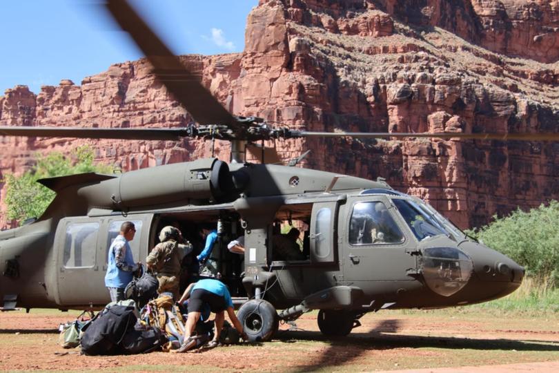 A Blackhawk evacuates 104 tourist and tribal members out of the Grand Canyon after flood waters impacted the Havasupai Reservation community and tourists visiting the Havasupai Falls. 