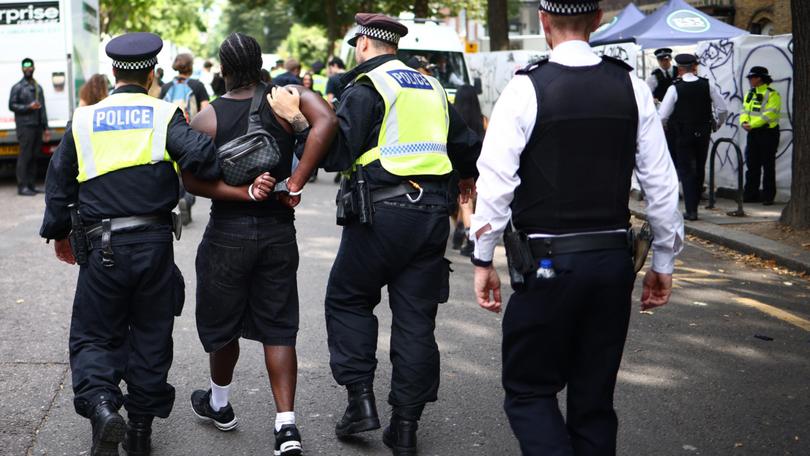 Police officers make an arrest at the Notting Hill Carnival in west London on August 26.