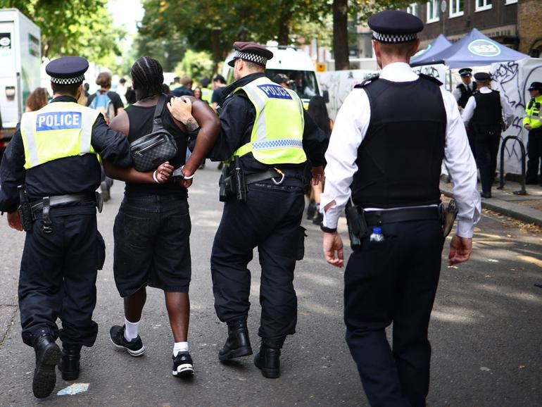 Police officers make an arrest at the Notting Hill Carnival in west London on August 26.