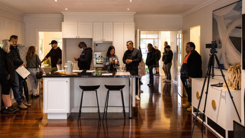 Bidders inside a home during an auction at Glen Iris in Melbourne