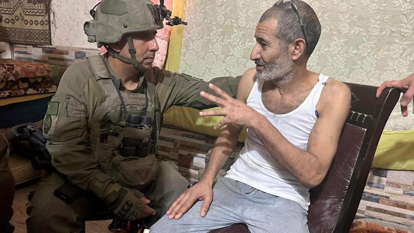 Qaid Farhan Alkadi talks to the commanding officer of the 162nd Division, Brig. Gen. Itzik Cohen, after his rescue. 