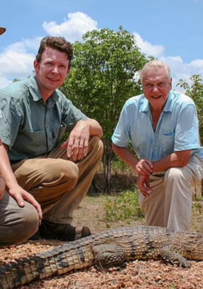 Adam Britton (centre) pictured with David Attenborough (right) Supplied