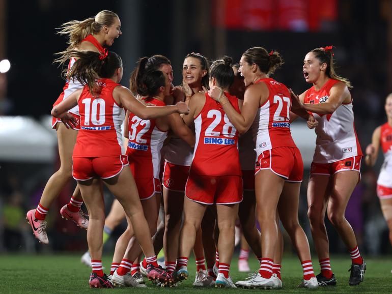 Chloe Molloy of the Swans celebrates kicking a goal.