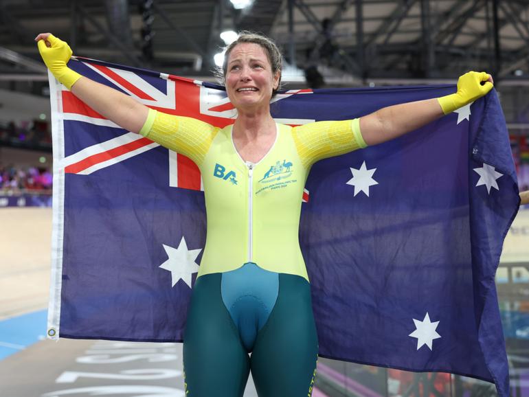 Emily Petricola of Team Australia celebrates with the flag of Australia after winning the Women's C4 3000m Individual Pursuit Final.