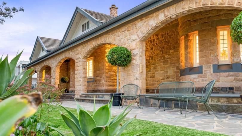 The landmark sandstone home has its own turret and a wraparound verandah.