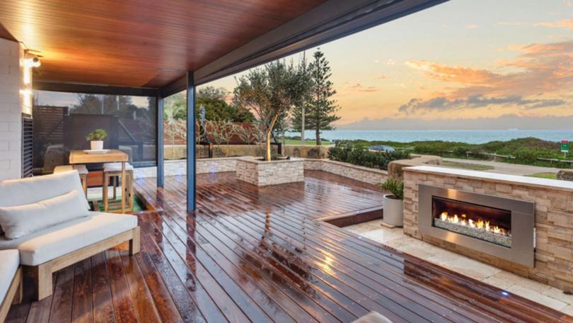 Taking in the ocean view is a year-round option at this Cottesloe apartment with its own outdoor fireplace.