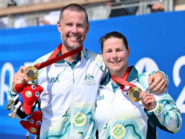 Jed Altschwager and Nikki Ayers display their gold medals.