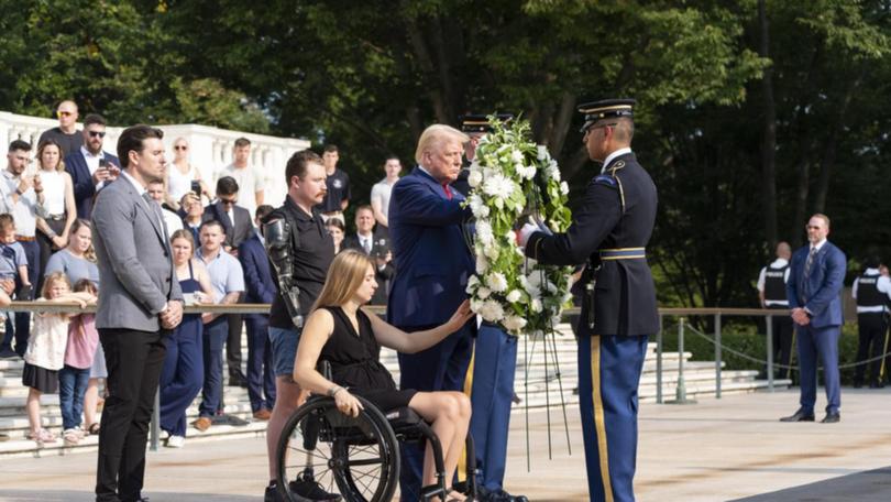 Donald Trump took part in a ceremony placing a wreath at Arlington National Cemetery. (AP PHOTO)