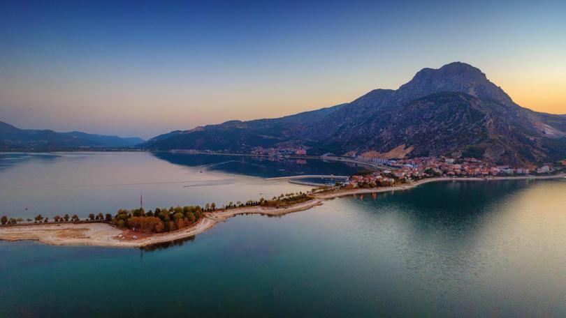 Aerial view of Eğirdir city situated on narrow spit down the big mountain on Eğirdir lake, Turkey Sergey Alimov