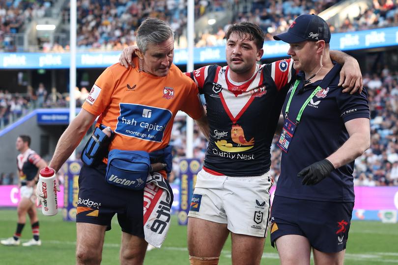 SYDNEY, AUSTRALIA - SEPTEMBER 01: Brandon Smith of the Roosters is helped off the field with an injury during the round 26 NRL match between Sydney Roosters and Canberra Raiders at Allianz Stadium, on September 01, 2024, in Sydney, Australia. (Photo by Cameron Spencer/Getty Images)