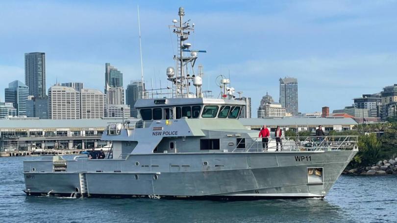 NSW water police vessel Nemesis is heading towards  a stricken yacht carrying two people. (Jack Gramenz/AAP PHOTOS)