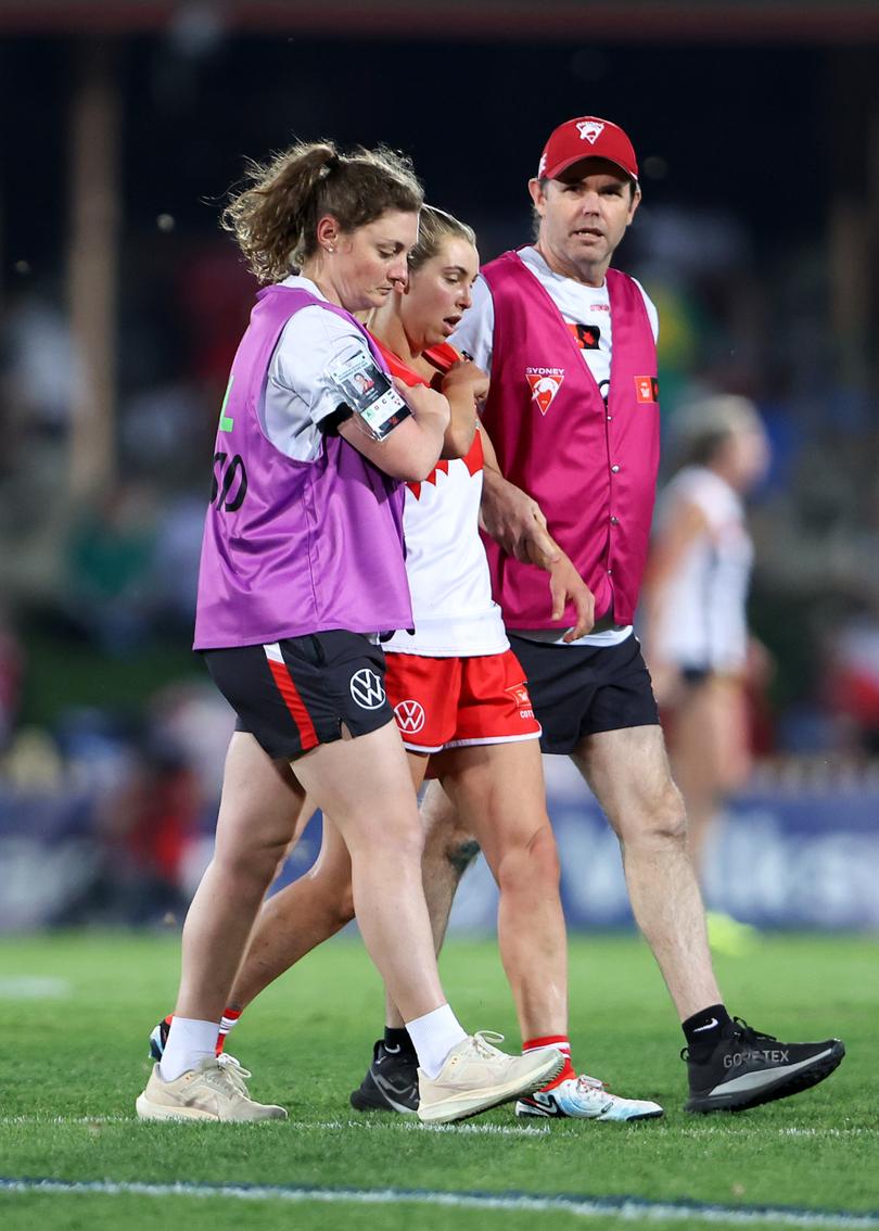 SYDNEY, AUSTRALIA - AUGUST 30: Maddy Collier of the Swans is helped from the field during the round one AFLW match between Sydney Swans and Collingwood Magpies at North Sydney Oval, on August 30, 2024, in Sydney, Australia. (Photo by Brendon Thorne/AFL Photos/via Getty Images)