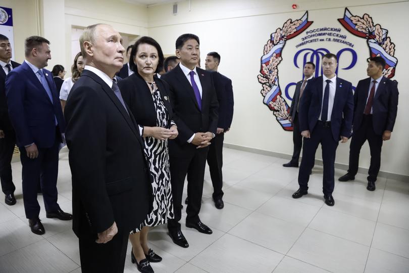 Russian President Vladimir Putin, left, and Mongolian President Ukhnaagiin Khurelsukh, centre, visit the school branch of the Plekhanov Russian University of Economics in Ulaanbaatar, Mongolia.