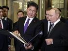 Russian President Vladimir Putin , right, and Mongolian President Ukhnaagiin Khurelsukh, centre.  