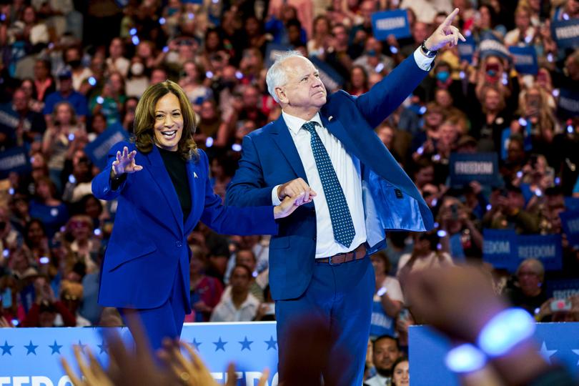 US Vice President Kamala Harris, left, and Tim Walz, governor of Minnesota and Democratic vice-presidential nominee, during a campaign event at Fiserv Forum in Milwaukee, Wisconsin, US, on Tuesday, Aug. 20, 2024. In the days following her rapid ascent to the top of the Democratic ticket, Harris quickly brought in a coterie of advisers from former President Barack Obama's White House and campaign efforts to join her team. Photographer: Bing Guan/Bloomberg