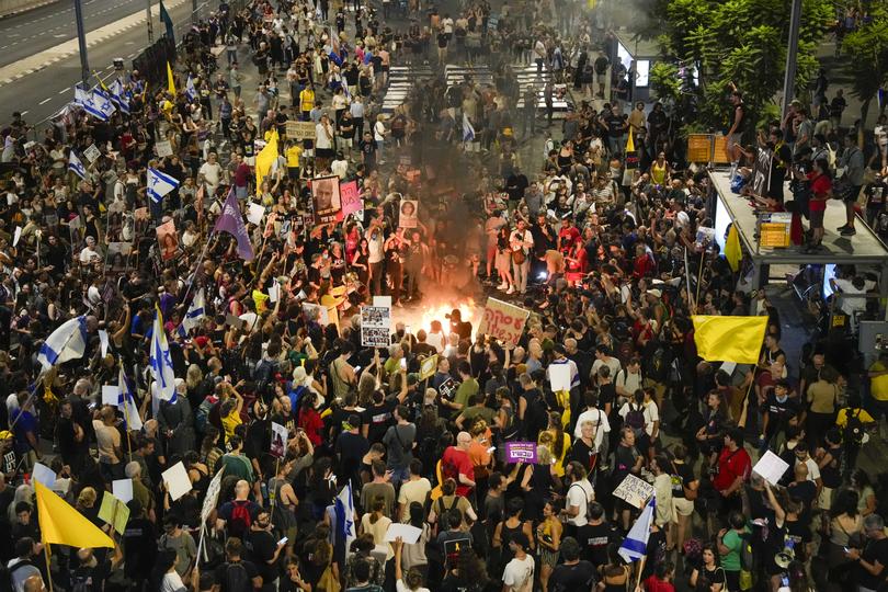 Demonstrators light a bonfire during a protest demanding a cease-fire deal and the immediate release of hostages held by Hamas in the Gaza Strip on Thursday, Sept. 5, 2024, in Tel Aviv, Israel. 