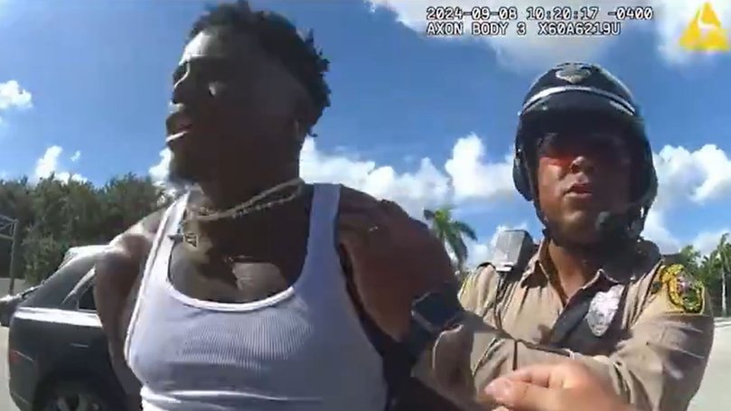 Tyreek Hill being detained.