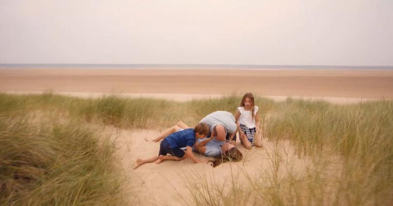 William and Kate tussle on the beach to the delight of their children, George, Charlotte and Louis. 