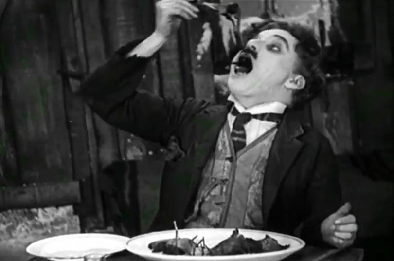 Charlie Chaplin cooks and eats a shoe in the 1925 film The Gold Rush