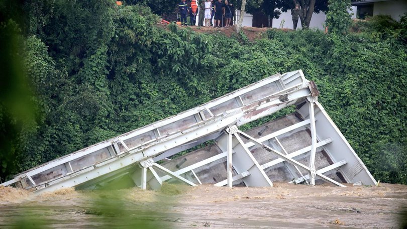 The collapsed Phong Chau bridge became submerged into the Red River after Typhoon Yagi hit Vietnam.