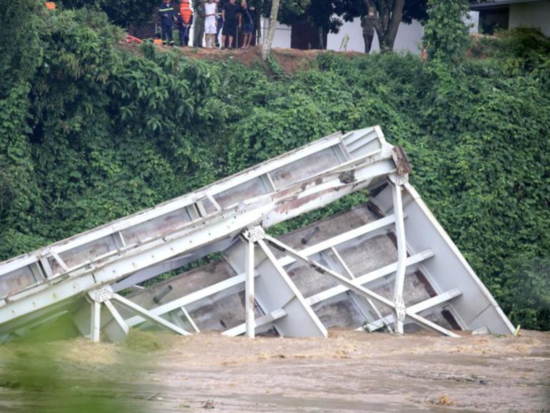 The collapsed Phong Chau bridge became submerged into the Red River after Typhoon Yagi hit Vietnam.