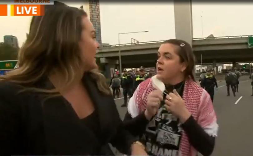 One woman with a keffiyeh around her shoulders covered the camera lens with her hand before Dolling tried to push her away.
