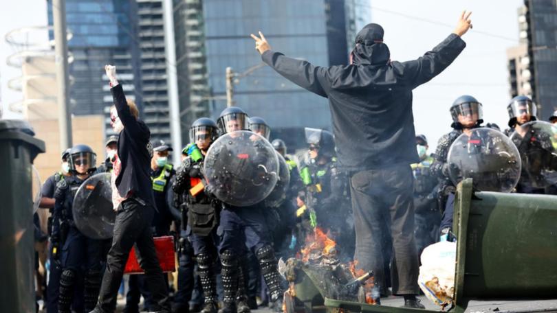 Protesters confront police during an anti-war rally outside a weapons expo in Melbourne.