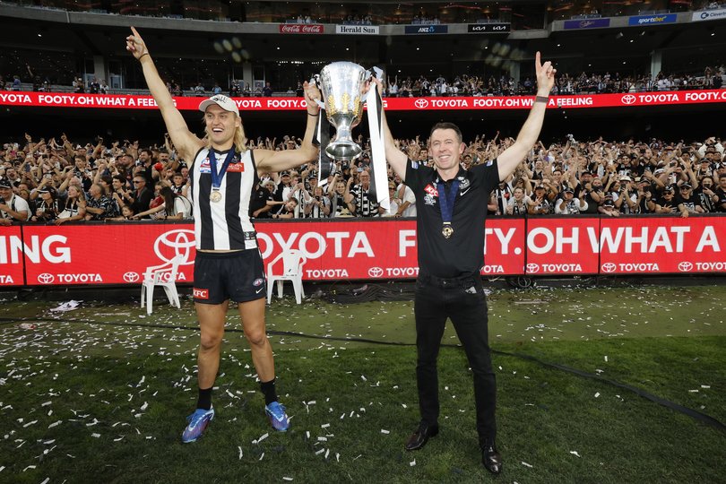 MELBOURNE, AUSTRALIA - SEPTEMBER 30: Darcy Moore of the Magpies and Craig McRae, Senior Coach of the Magpies poses with the Premiership Cup after the 2023 AFL Grand Final match between Collingwood Magpies and Brisbane Lions at Melbourne Cricket Ground, on September 30, 2023, in Melbourne, Australia. (Photo by Darrian Traynor/AFL Photos/via Getty Images)