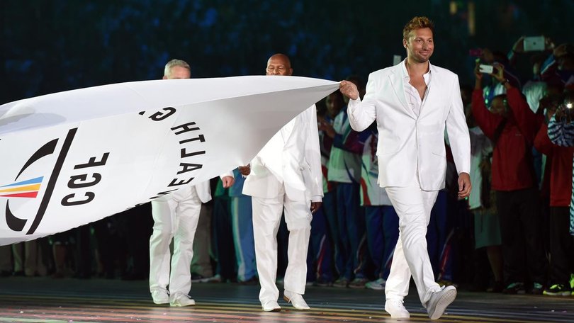 Ian Thorpe carries the Commonwealth Games Federation flag at Glasgow's opening ceremony in 2014. (Dean Lewins/AAP PHOTOS)